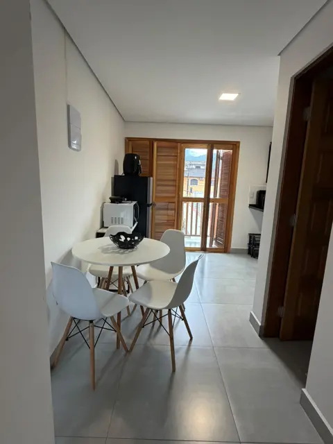 Apartamento para família em Maresias: sala de jantar com porta para a área externa
